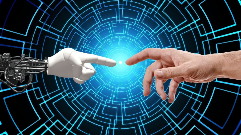 An image depicting a robotic hand and a human hand positioned close to each other, their fingers nearly touching, symbolizing the intersection of technology and humanity, highlighting the potential collaboration and interaction between humans and robots.
